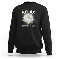 Black sweatshirt with “RELAX” and lotus graphic on the back