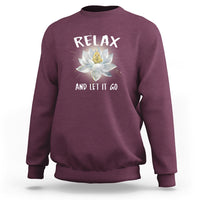 Maroon sweatshirt with “RELAX” and lotus graphic on the back