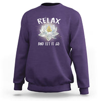 Purple sweatshirt with “RELAX” and lotus graphic on the back