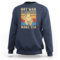 Blue crewneck sweatshirt with Buddha graphic and 'NOT WAR MAKE TEA' text.