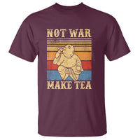 Maroon Buddha graphic T-shirt with “NOT WAR” and “MAKE TEA” text