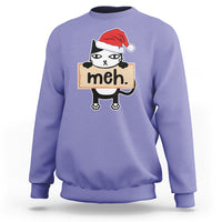Violet sweatshirt with cartoon black cat wearing Santa hat and “meh” sign front print.