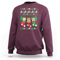Maroon crewneck sweatshirt with cute cat-in-socks Christmas graphic.