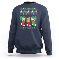 Navy crewneck sweatshirt with cute cat-in-socks Christmas graphic.