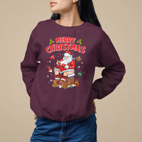 Maroon crewneck sweatshirt with 'MERRY CHRISTMAS' Santa graphic and cartoon ornaments