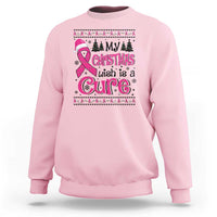 Light pink sweatshirt with front 'Christmas wish is a Cure' graphic, trees and ribbon