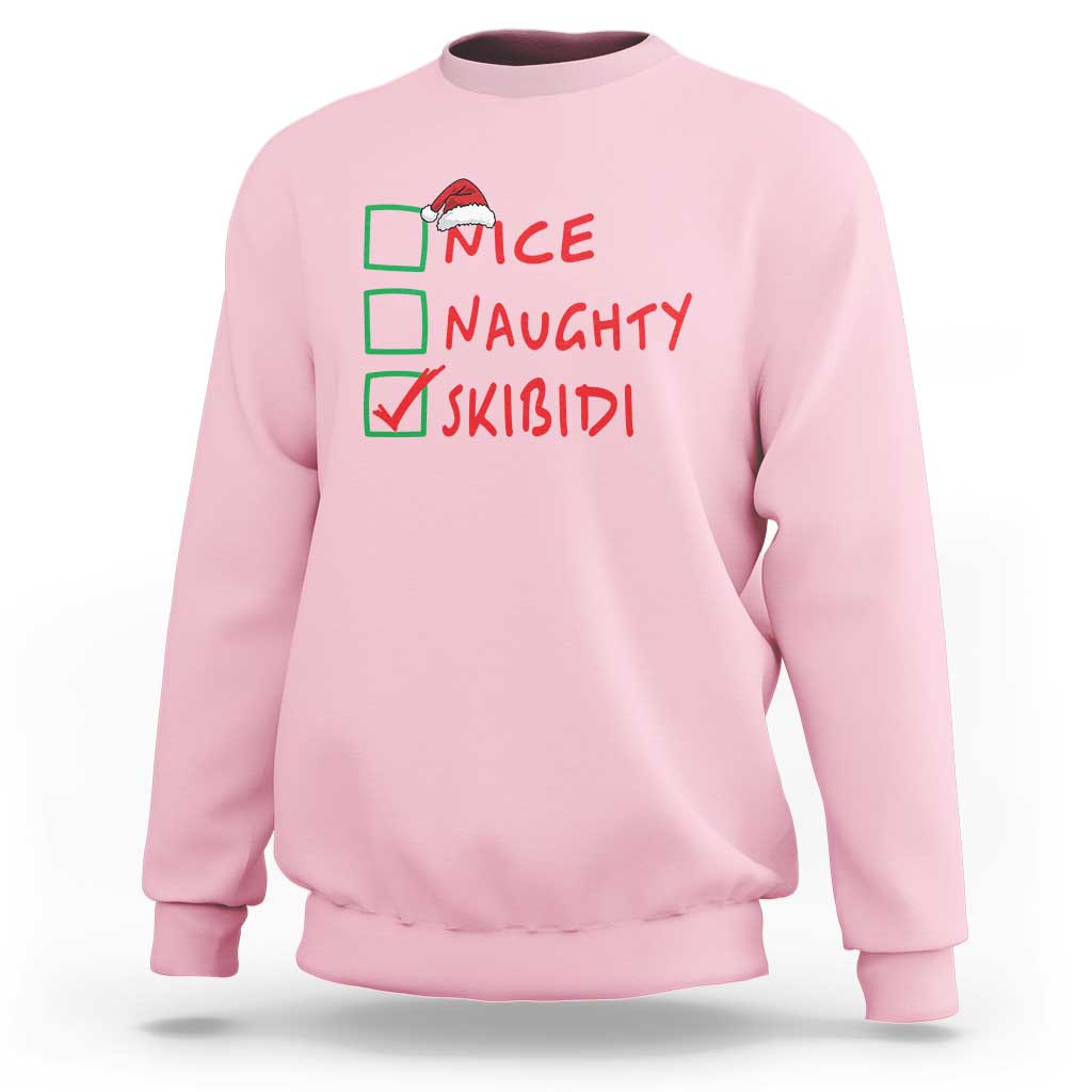 Light pink Christmas sweatshirt with “NICE NAUGHTY SKIBIDI” graphic on chest