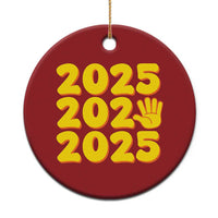 Red 2025 holiday ornament with yellow “2025” and handprint icon, round shape