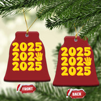 Red bell-shaped 2025 ornament with yellow “2025” text and handprint icon