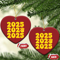 Red heart-shaped 2025 ornament with yellow “2025” text and handprint icon