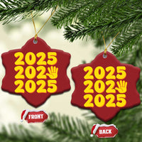 Two red heart-shaped 2025 ornaments with yellow “2025” and handprint icon