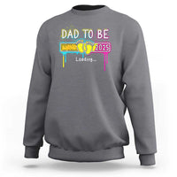 Charcoal gray sweatshirt with “Dad to Be 2025” colorful loading graphic on front
