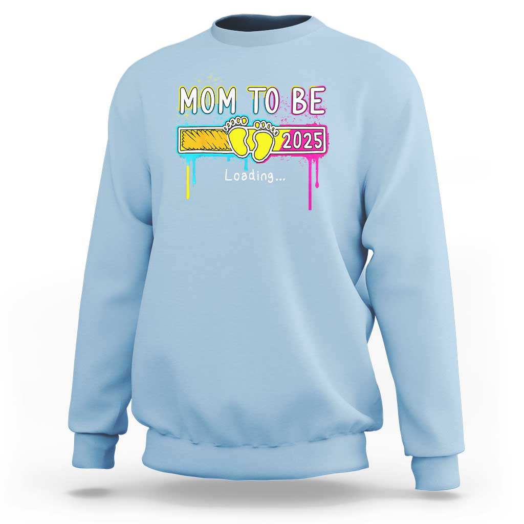 Light blue mom-to-be sweatshirt with colorful “Mom to be 2025” loading graphic on front