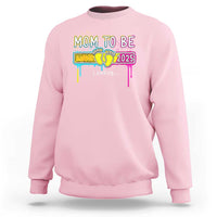 Light pink mom-to-be sweatshirt with colorful “Mom to be 2025” loading graphic on front
