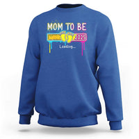Royal blue mom-to-be sweatshirt with colorful “Mom to be 2025” loading graphic on front