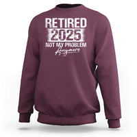 Maroon crewneck sweatshirt with 'Retired 2025' and 'Not My Problem' graphic