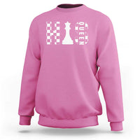 Pink crewneck sweatshirt with white chessboard and queen graphic on the chest