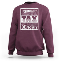 Maroon crewneck sweatshirt with Survived Tax Season front graphic