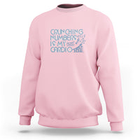 Light pink crewneck sweatshirt with teal 'Crunching numbers is my cardio' graphic