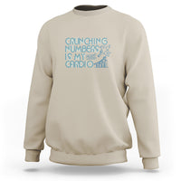 Beige crewneck sweatshirt with teal 'Crunching numbers is my cardio' graphic
