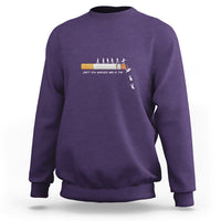Purple long-sleeve sweatshirt with centered graphic and ribbed crewneck cuffs.