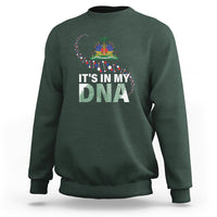 Dark green crewneck sweatshirt with colorful “It’s in My DNA” graphic on chest