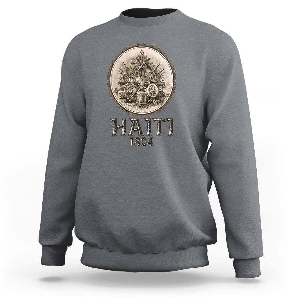 Gray crewneck sweatshirt with front circular emblem and HAITI 1804 lettering.