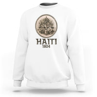 White crewneck sweatshirt with front circular emblem medallion and HAITI 1804 text.