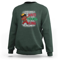 Dark forest green kids sweatshirt with “HAITI YOUNG KING” graphic and cartoon character on front