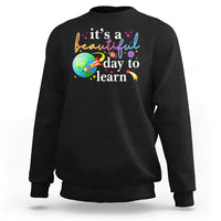 Black crewneck sweatshirt with "it's a beautiful day to learn" graphic
