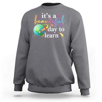 Charcoal gray crewneck sweatshirt with "it's a beautiful day to learn" graphic
