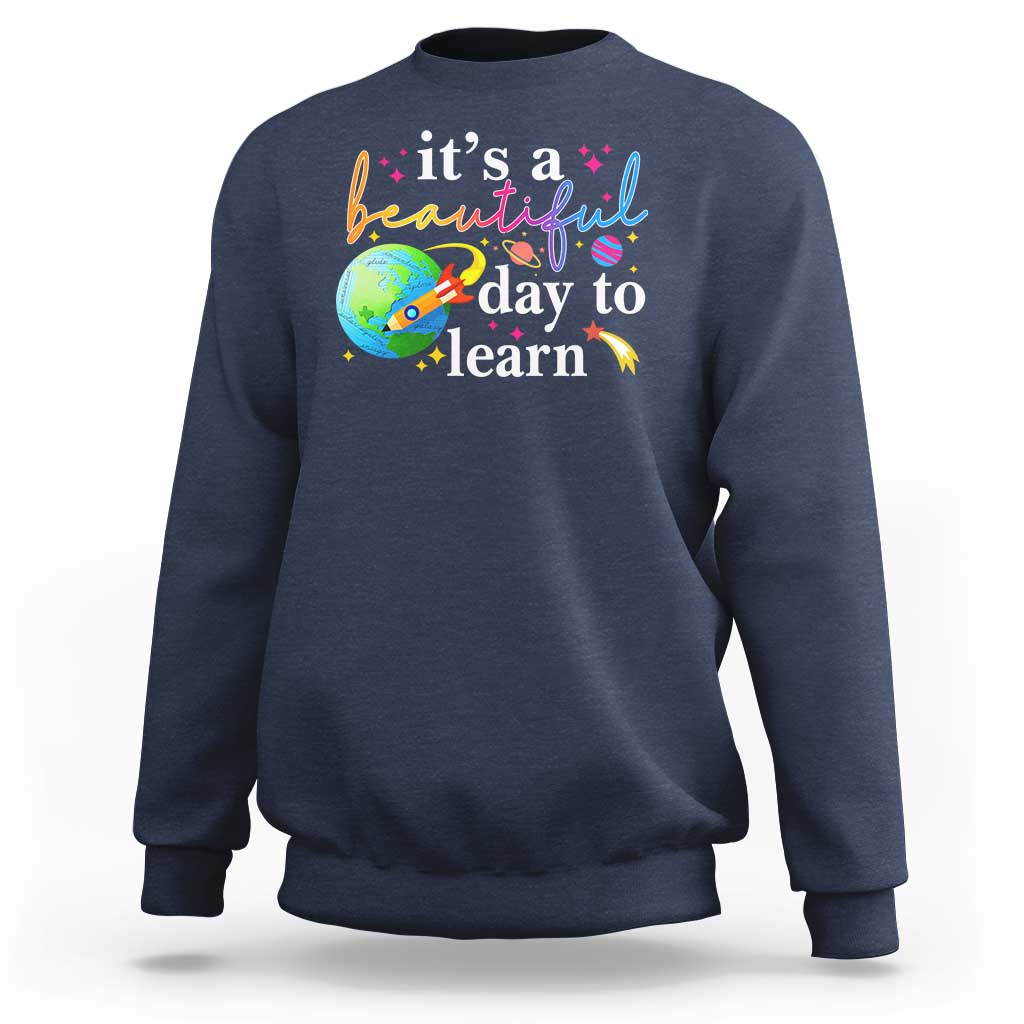 Navy crewneck sweatshirt with "it's a beautiful day to learn" graphic