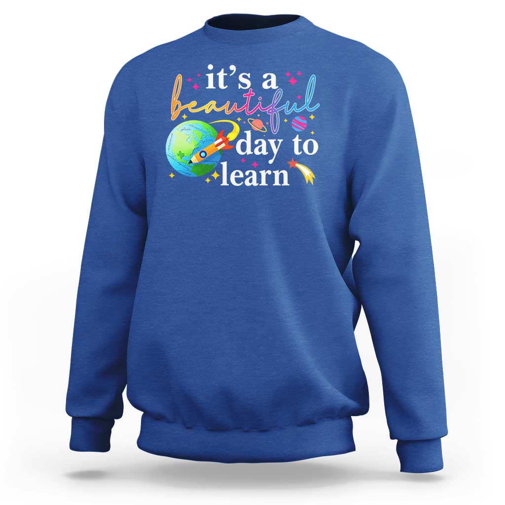 Royal blue crewneck sweatshirt with "it's a beautiful day to learn" graphic