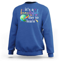 Royal blue crewneck sweatshirt with "it's a beautiful day to learn" graphic
