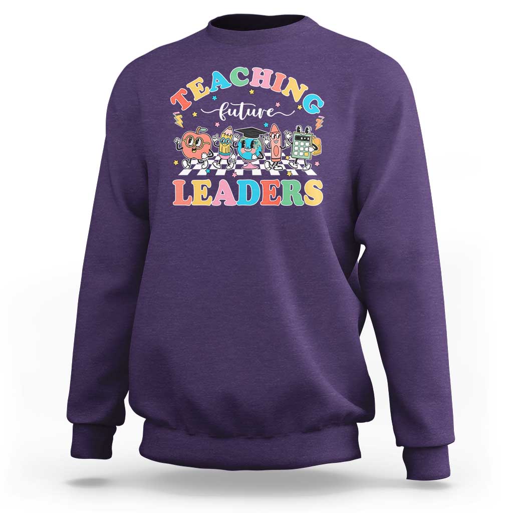 Purple teacher sweatshirt with colorful “Teaching Future Leaders” character graphic