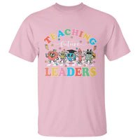 Light pink teacher T-shirt with “Teaching Future Leaders” colorful graphic