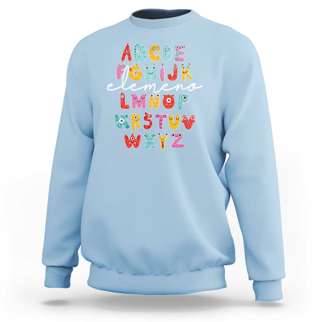 Light blue sweatshirt with cute monster alphabet A–Z graphic on front.