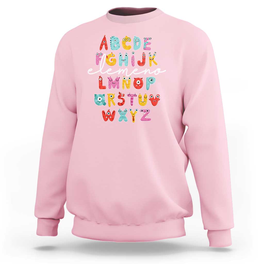 Light pink sweatshirt with cute monster alphabet A–Z graphic on front.