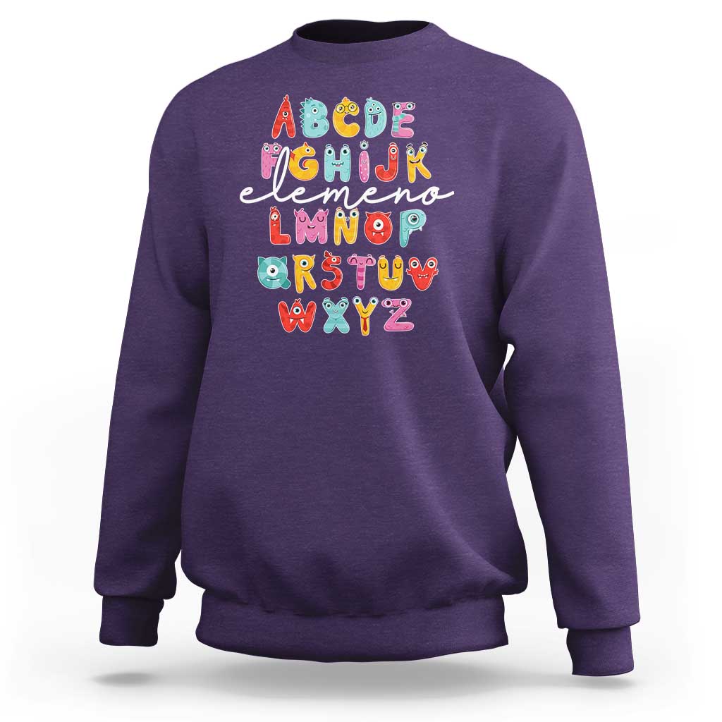 Purple sweatshirt with cute monster alphabet A–Z graphic on front.