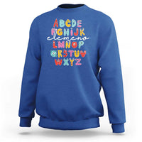 Royal blue sweatshirt with cute monster alphabet A–Z graphic on front.