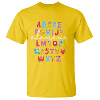 Yellow alphabet monster T-shirt with colorful letter blocks graphic on front