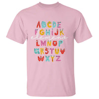 Light pink alphabet monster T-shirt with colorful letter blocks graphic on front