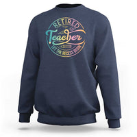 Navy crewneck sweatshirt with “Retired Teacher” circular graphic on the chest