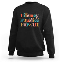 Black crewneck sweatshirt with “Literacy & Justice For All” front graphic