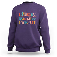 Purple crewneck sweatshirt with “Literacy & Justice For All” front graphic
