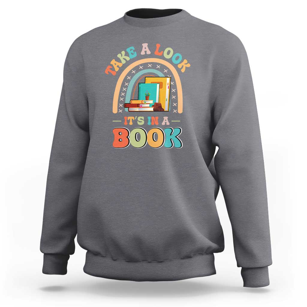 Gray librarian sweatshirt with colorful “It’s in a Book” front graphic.