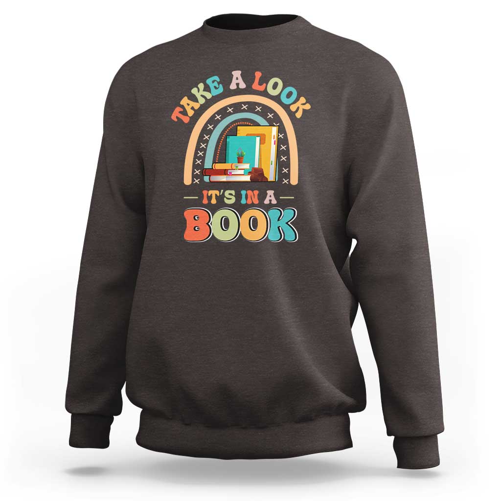 Dark brown librarian sweatshirt with colorful “It’s in a Book” front graphic.