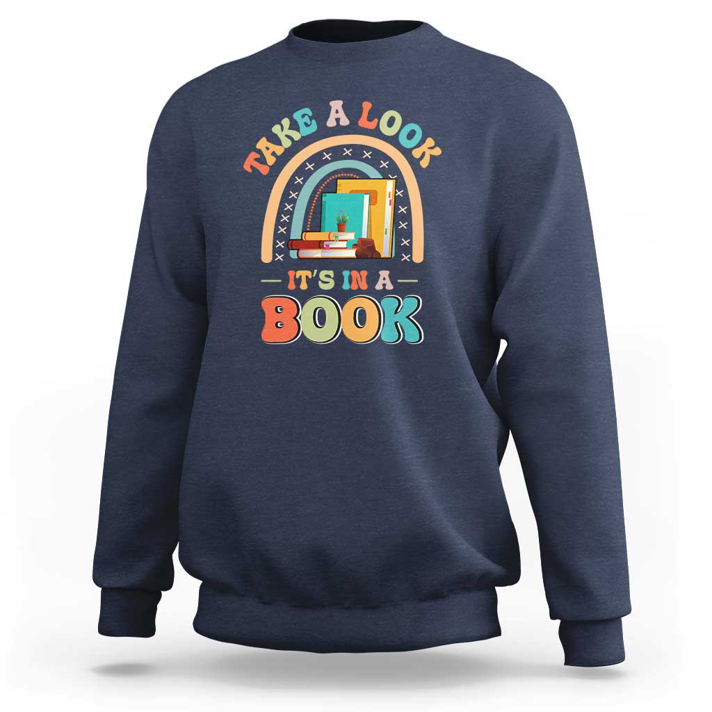 Navy librarian sweatshirt with colorful “It’s in a Book” front graphic.