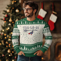 Green ugly Christmas sweater with bird graphic, pine trees, and festive fair isle stripes