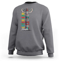 Gray crewneck sweatshirt with multicolor totem pole graphic and 'Alaska' text